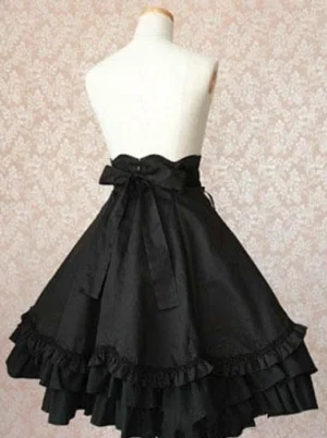 Black gothic lolita military skirt back view showing large bow sash at waist and double layered ruffled hem detail