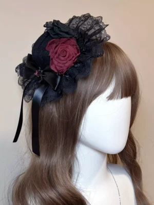 Gothic Lolita mini headdress with black lace and burgundy rose worn on mannequin three-quarter left view showing intricate design details
