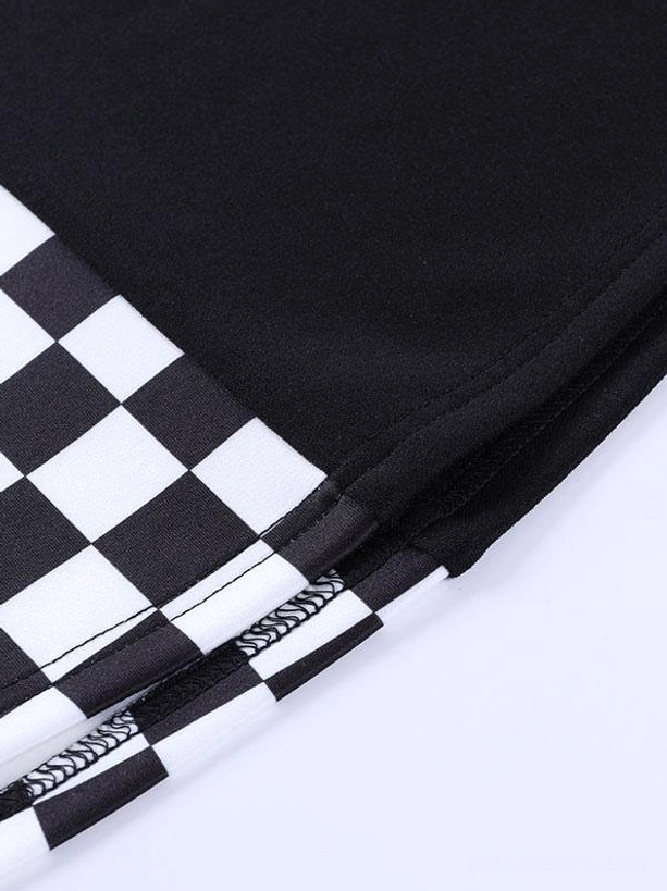 Close-up detail of folded black-white checkerboard fabric on gothic lolita mini skirt, showing crumpled texture and color contrast