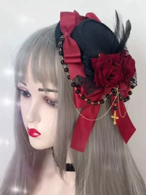 Gothic Lolita mini top hat hair clip with burgundy bow red roses and beaded cross chain displayed on wig mannequin left three-quarter angle view