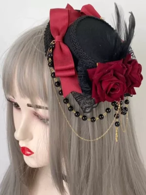 Gothic Lolita mini top hat hair clip with burgundy bow red roses and beaded cross chain displayed on wig mannequin right three-quarter angle view