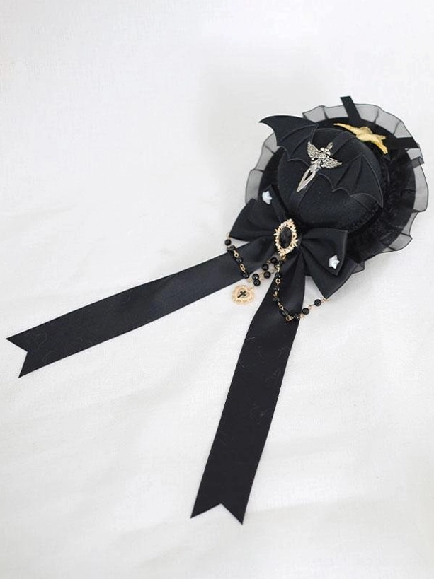 Gothic lolita mini top hat hairclip left side flat view displaying black satin bow with bead tassel and bat wing ornament decoration