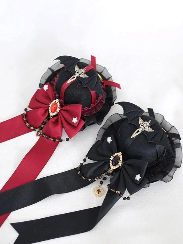 Two styles of gothic lolita mini top hat hairclips shown together flat lay front view wine red bow style and black bow style both featuring bat wing decorative elements