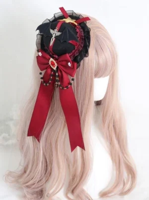 Gothic lolita mini top hat hairclip with wine red satin bow and bead chain decorative elements on black base, mannequin three-quarter back view