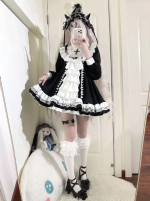 Gothic Lolita nun costume dress black and white full-body mirror selfie view showing complete silhouette with ruffled lace trims and cross chest ornament