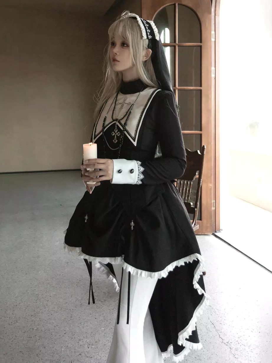 Full side standing view of gothic lolita dress showcasing stand-up collar, asymmetric high-low hem with white ruffle, cross embroidery details, elegant silhouette against wooden glass door backdrop