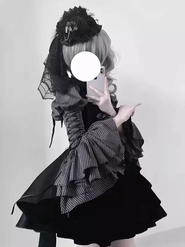Front side mirror selfie perspective of Gothic Lolita 3-piece set displaying flared striped ruffled sleeves, black layered mini skirt, and lace veil headpiece styling