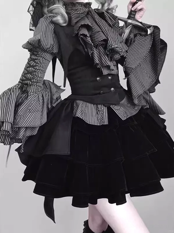 Close-up detail of Gothic Lolita outfit upper and lower torso showing embellished striped ruffled collar blouse, fitted black waistcoat, and layered velvet mini skirt construction