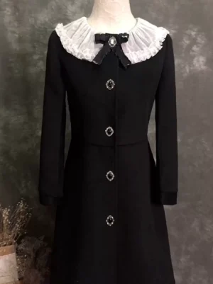 Gothic Lolita winter coat upper body close-up showing black fabric white ruffled peter pan collar and decorative front gem buttons detail