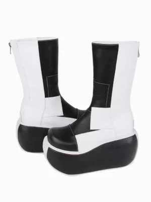 Back zipper closure detail on patchwork gothic lolita boots rear three-quarter angle showing black and white geometric pattern and mid-calf shaft height