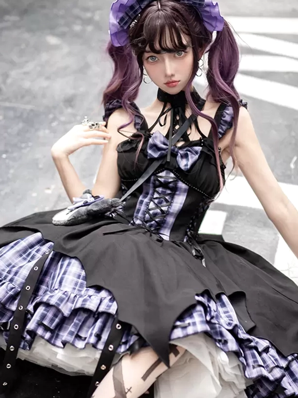 Gothic Lolita plaid jumper dress close-up front view showing chest bow decoration and grommet embellishments on skirt