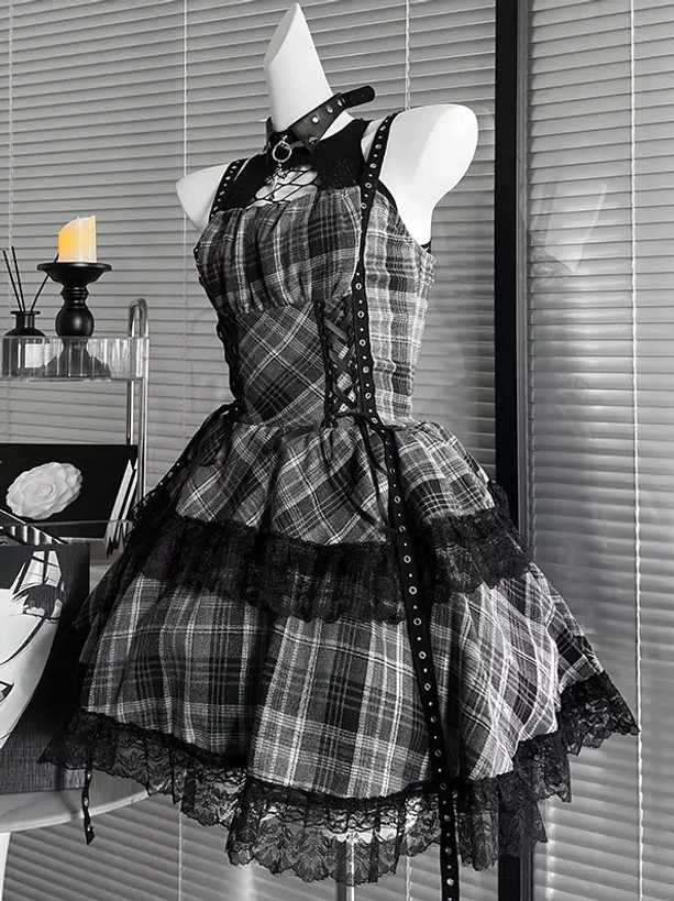 Front-facing grey and black plaid gothic lolita JSK dress with spaghetti straps, sweetheart lace neckline, rivet-embellished lace-up center panel, and dramatic plaid pattern