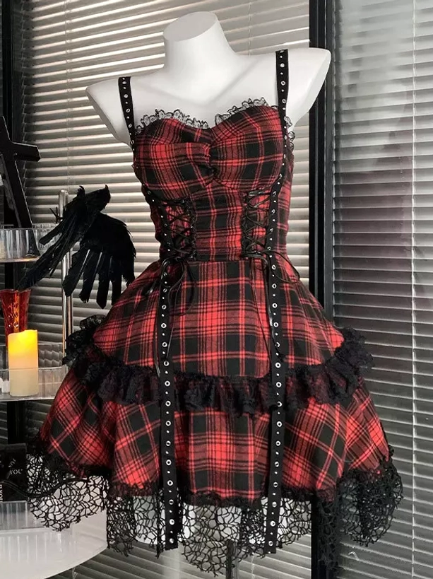 Front-facing gothic lolita JSK dress in red and black plaid with spaghetti straps, sweetheart neckline, and rivet-embellished lace-up center panel, showing full dress silhouette