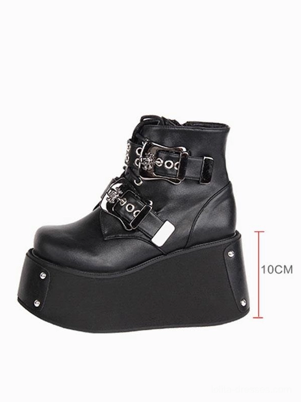 Black gothic platform ankle boots side profile showing 10cm thick wedge sole round toe and metal studs on sole edge with height marker