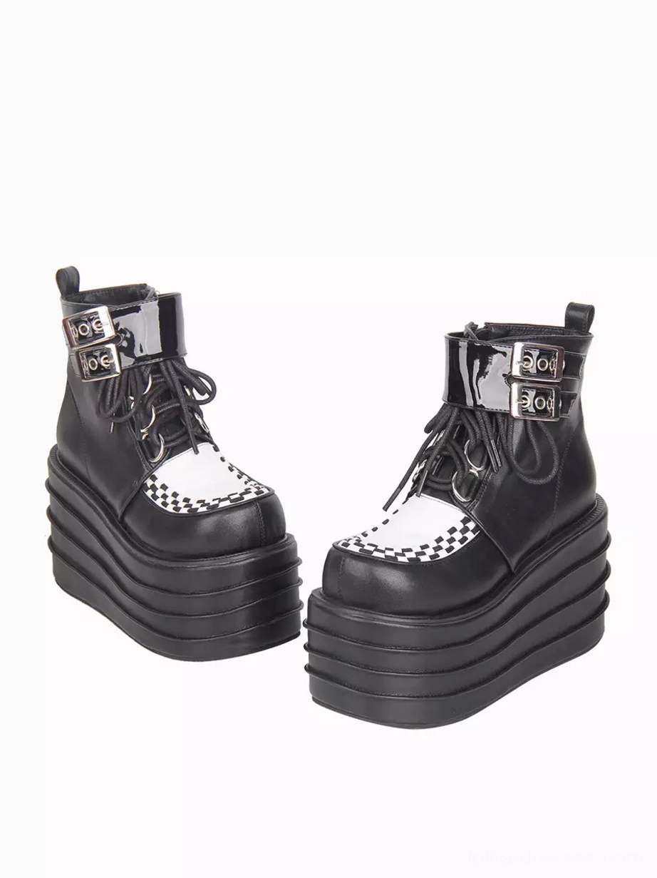 Back oblique angle view of paired gothic lolita platform ankle boots showing matching checkerboard toe caps and thick stacked platform foundation