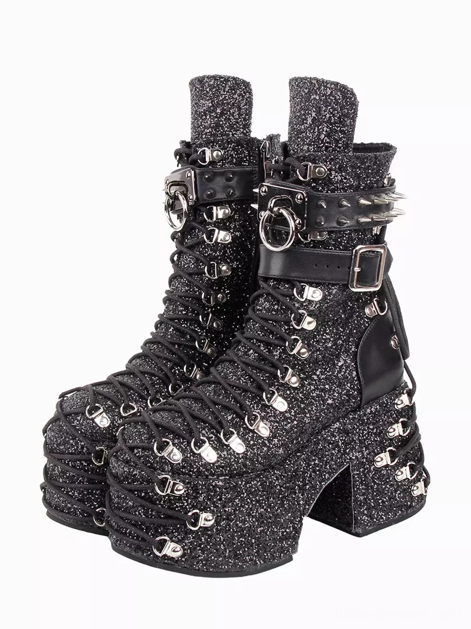 Gothic lolita platform boots with black glitter fabric and silver grommets, front oblique view showing chunky wedge heel and decorative hardware details