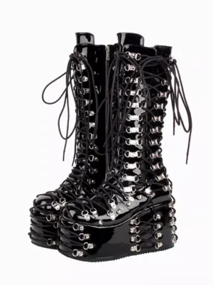 Black Gothic Lolita platform boots with silver grommet lace-up details displayed as a front-facing pair on white background, showcasing patent leather finish and round toe design