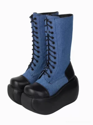 Blue denim and black leather two-tone gothic lolita platform boots with lace-up closure and chunky wedge sole, shown as a pair from left three-quarter angle