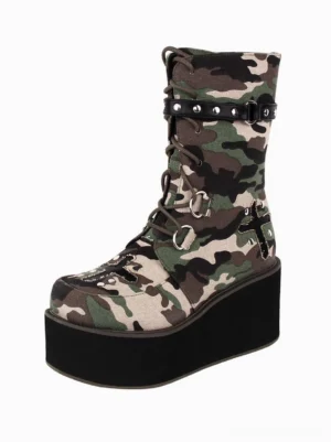 Gothic lolita platform boots with camouflage canvas upper and metal grommets, left front three-quarter view showcasing studded leather strap and round thick wedge sole