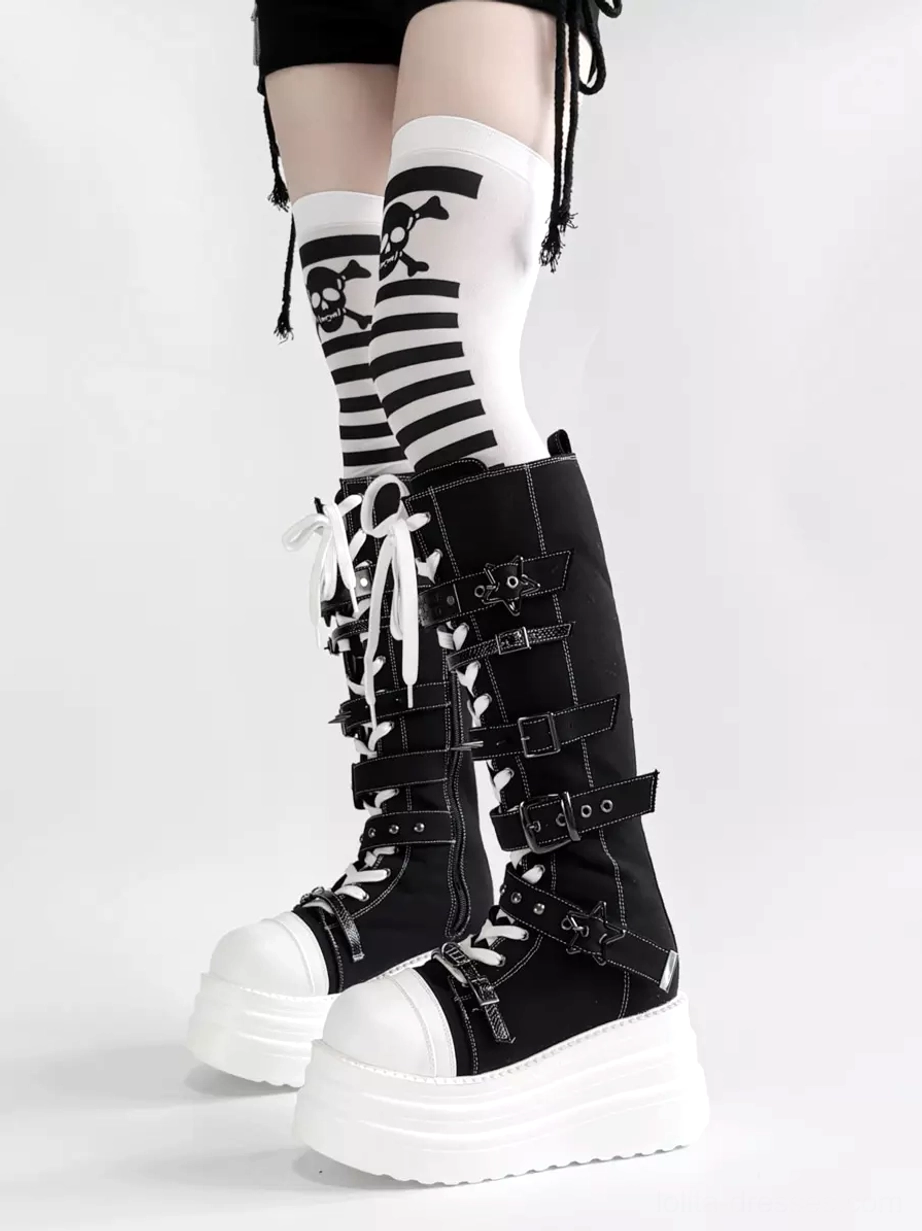 Side low view of gothic lolita platform boots featuring thick white chunky platform, black canvas body, adjustable metal buckles, and matching skull stripe over-the-knee socks pairing