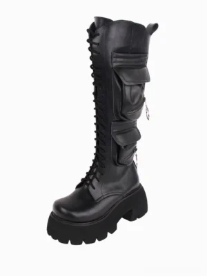 Gothic lolita knee-high boots three-quarter front angle showcasing rounded toe, metal zipper pulls, thick ridged platform sole, and structured silhouette