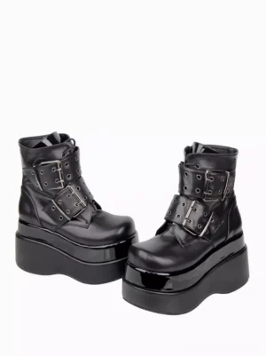 Black gothic lolita platform boots flat frontal paired view showing adjustable grommet buckle straps and thick high patent wedge sole on white background
