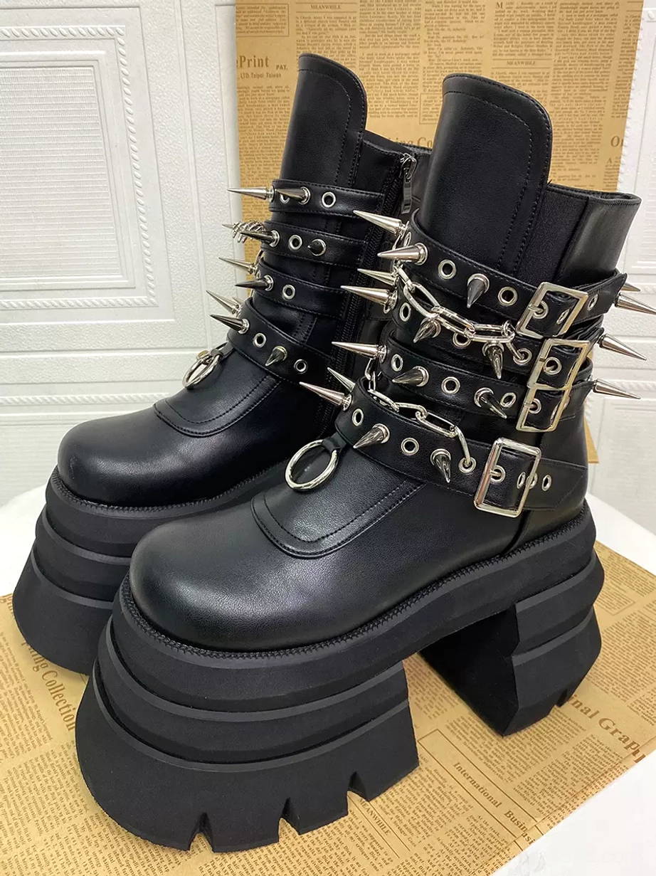 Gothic Lolita platform boots pair left three-quarter view matte black leather finish chunky lug platform soles silver metal accents vintage newspaper
