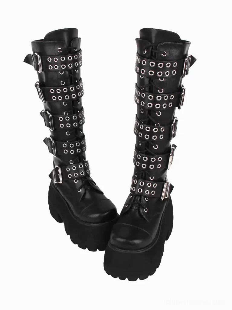 Side three-quarter paired view of black gothic lolita platform boots displaying grommet-decorated straps, chunky platform sole, and mid-calf shaft height