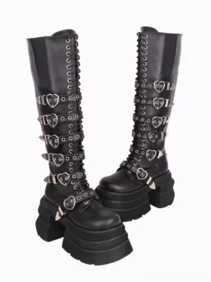 Side view of black gothic lolita platform knee-high boots showing chunky platform sole multiple heart-shaped buckles and decorative grommets