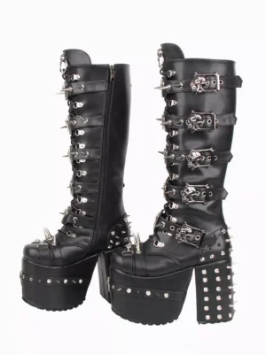 Gothic lolita knee-high platform boots side view displaying side zipper closure, skull-shaped buckles, silver spike decorations, and thick studded wedge heel design