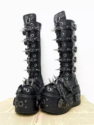 Punk style tall platform gothic lolita boots with skull metal fasteners and spike trims newspaper background display