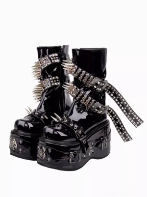 Gothic Lolita platform ankle boots with spiked metallic rivets, front oblique view showing patent black PU leather, studded buckle straps, and thick wedge sole