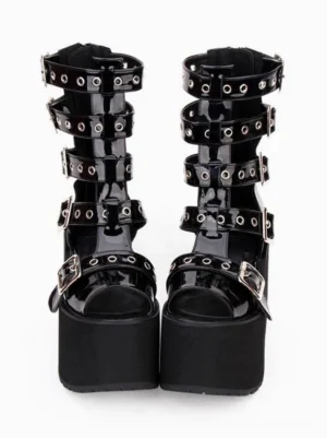 Gothic lolita platform gladiator sandals with metal grommet buckles front flat view showing black patent leather open toe design thick chunky block heel