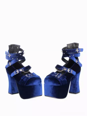 Pair of royal blue Gothic Lolita platform heels displaying side three-quarter profile view highlighting spike studs on ankle strap, thick platform sole and adjustable buckle system on plain white background