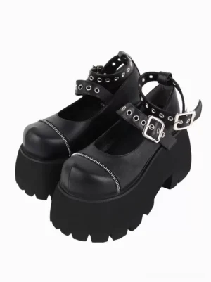 Gothic Lolita platform Mary Jane shoes front oblique view with dual buckle straps and metallic grommets on black matte PU leather with serrated thick platform sole
