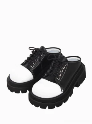 Gothic lolita platform mule sandals front oblique view showcasing black and white round toe cap contrast design with lace-up closure and chunky lug sole