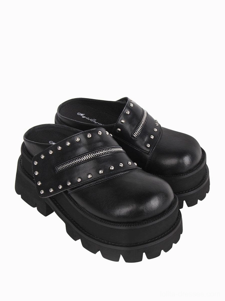 Front oblique view of gothic Lolita platform mule sandals displaying polished PU leather finish, heavy rubber lug sole, and rivet embellishments