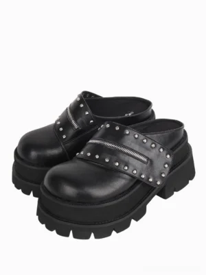 Pair of black gothic Lolita platform mule sandals with matching studded zipper straps and thick platform soles, front view on white background
