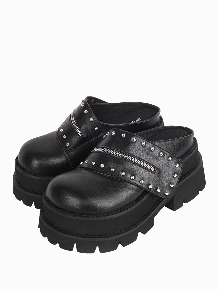 Pair of black gothic Lolita platform mule sandals with matching studded zipper straps and thick platform soles, front view on white background