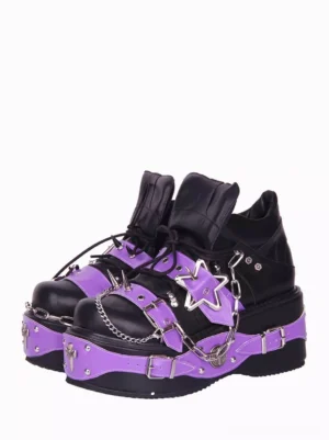 Gothic lolita platform pumps front three-quarter view featuring black and purple two-tone leather with star metal decorations and chain embellishments on wedge heel shoes