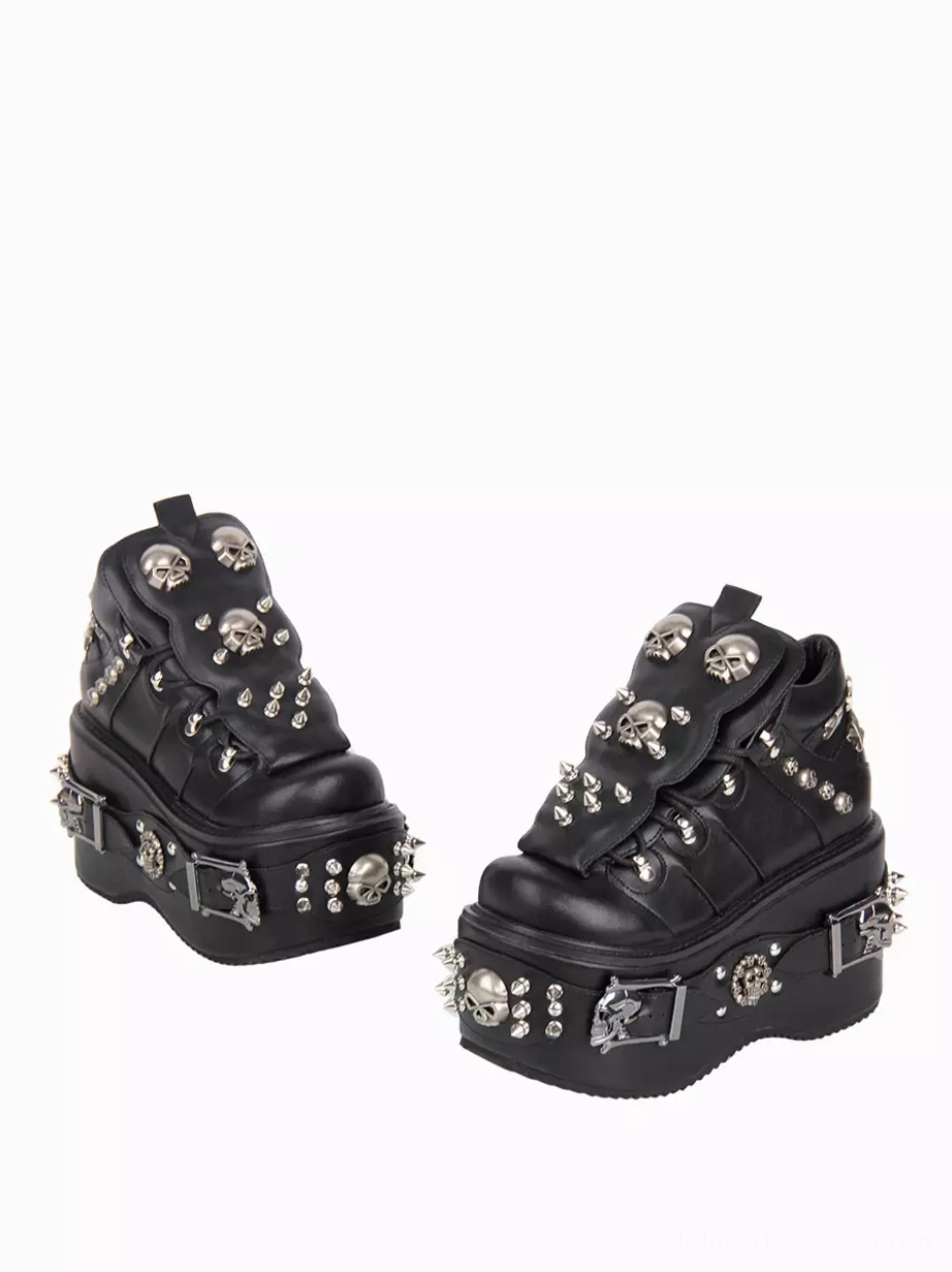 Pair of Gothic platform shoes low-angle front side paired view miniature perspective metal skull spike decorations thick wedge