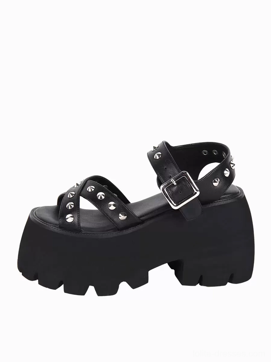 Single black Gothic Lolita platform sandal outer side view highlighting studded adjustable ankle strap and textured serrated chunky platform sole construction