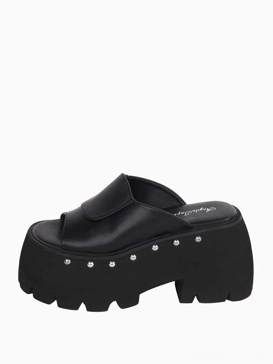 Single black Gothic Lolita platform sandal three-quarter side angle revealing the serrated thick sole, smooth PU leather finish, and structural wedge profile