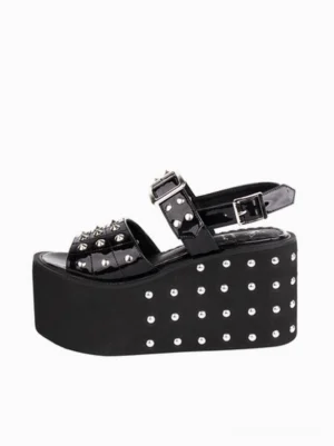 Single black Gothic Lolita platform sandal side three-quarter view, patent PU finish, silver studs on ankle strap and sole edge, buckle fastener detail, studio white background