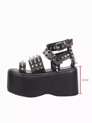 Side profile view of single gothic platform sandal displaying 10cm thick wedge sole and open toe design with metal spike decorations and scale reference
