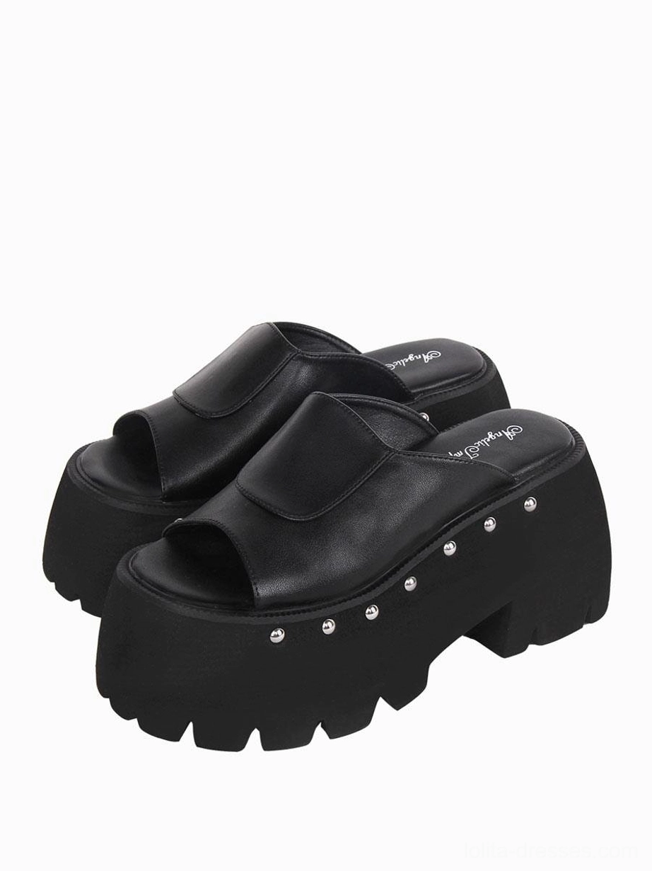 Overlapping pair of black Gothic Lolita platform sandals three-quarter front view showcasing the round toe shape and comprehensive rivet embellishment design