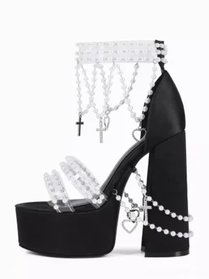 Gothic Lolita platform sandals with pearl chains and cross charms, side-front view single shoe black chunky heel