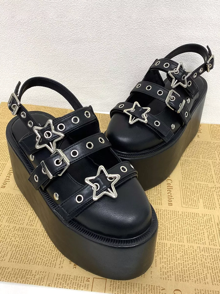 Black gothic lolita platform sandals oblique front view with multiple star buckles grommeted straps and wide platform base
