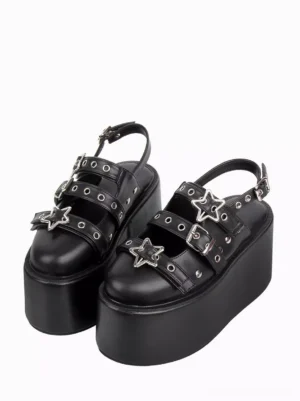 Black Gothic Lolita platform sandals with star metal buckles and grommeted straps front three-quarter view on white background
