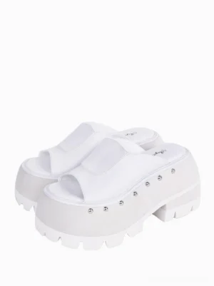 White Gothic Lolita platform sandals with silver rivet embellishments, three-quarter front angle displaying round toe design and architectural wedge platform